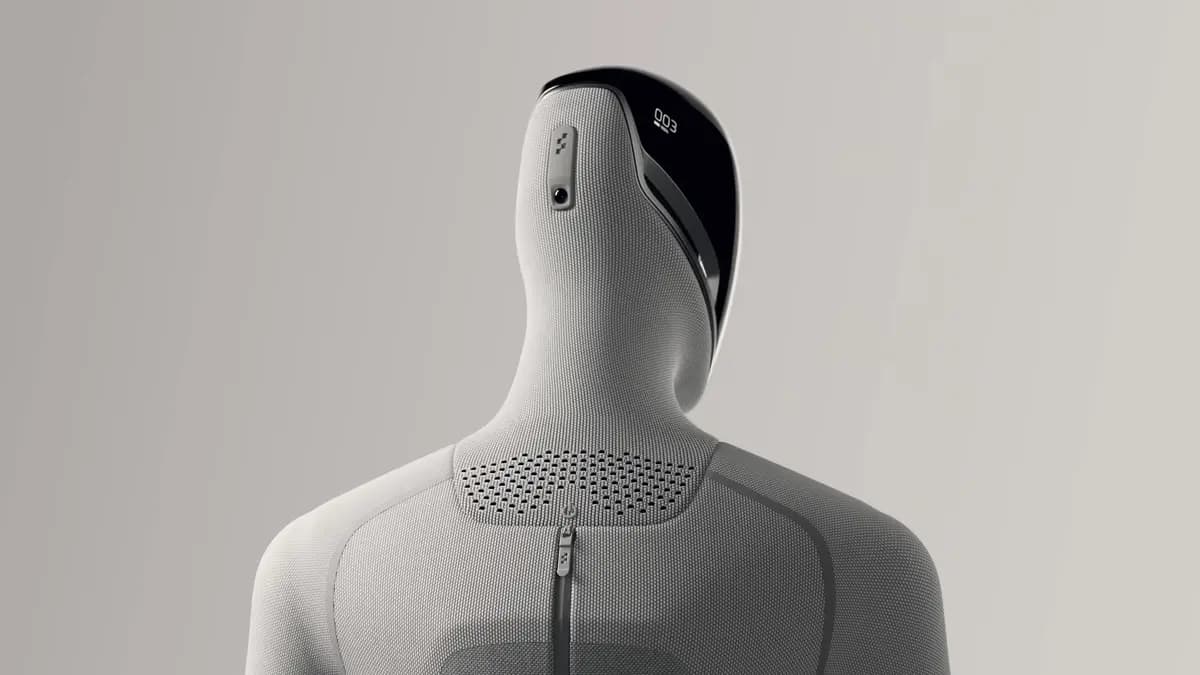 A CGI render of the Figure 03 humanoid robot shown from the back, highlighting its sleek form and grey fabric covering.