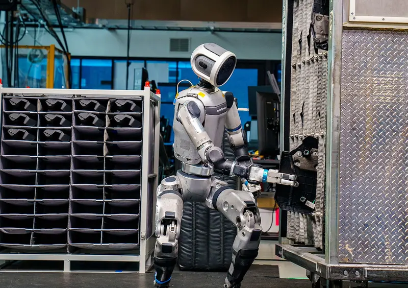 Boston Dynamics humanoid robot Atlas is working in a warehouse setting