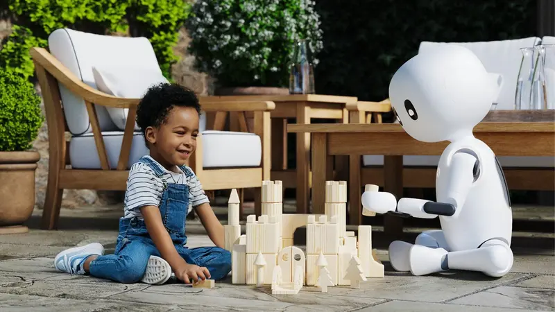 A computer render of a Cartwheel Robotics humanoid robot playing with a child