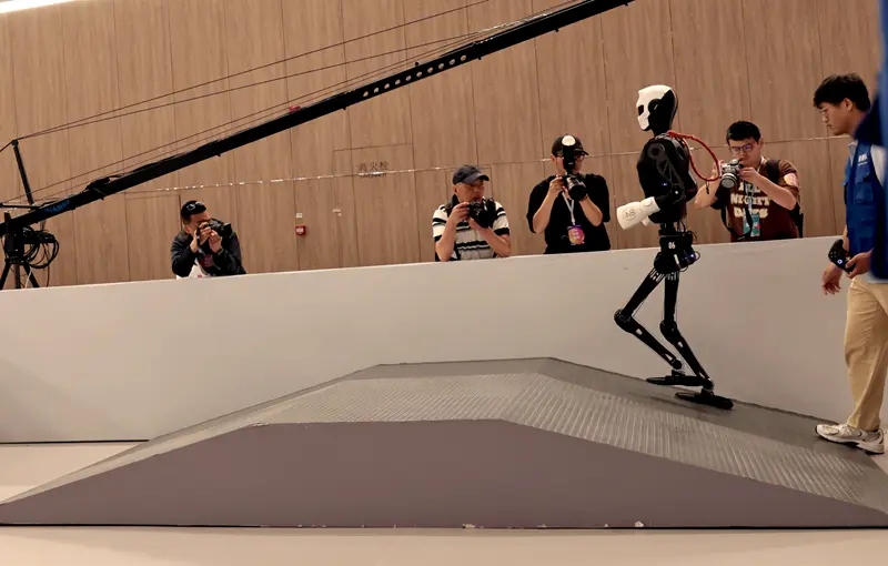 A humanoid robot competing in the All-Terrain Dynamic Challenge at the Embodied Intelligence Developer Conference in Shanghai China