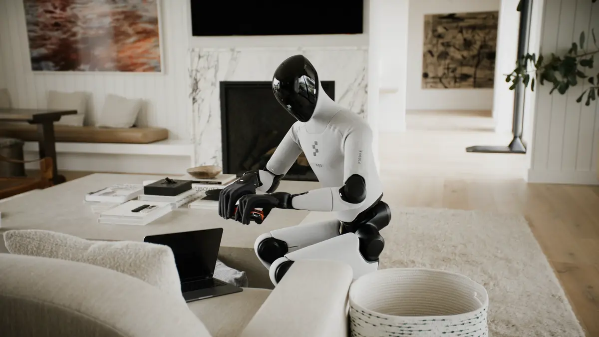 The Figure 03 robot is shown tidying up a living room, picking up items from a coffee table.