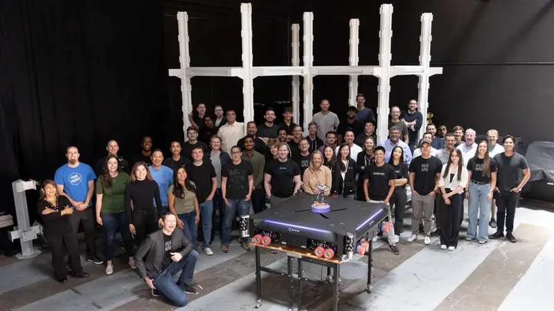 Robot company Mytra staff stands with one of their warehouse logistics robot