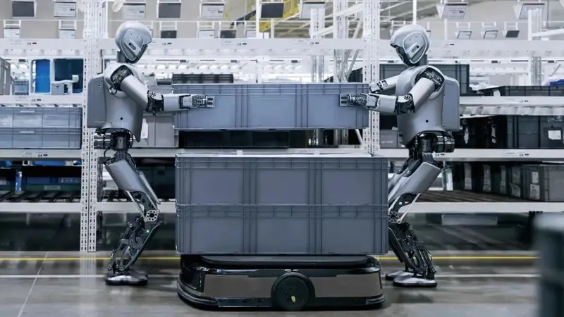 Two UBtech humanoid robots working at a factory