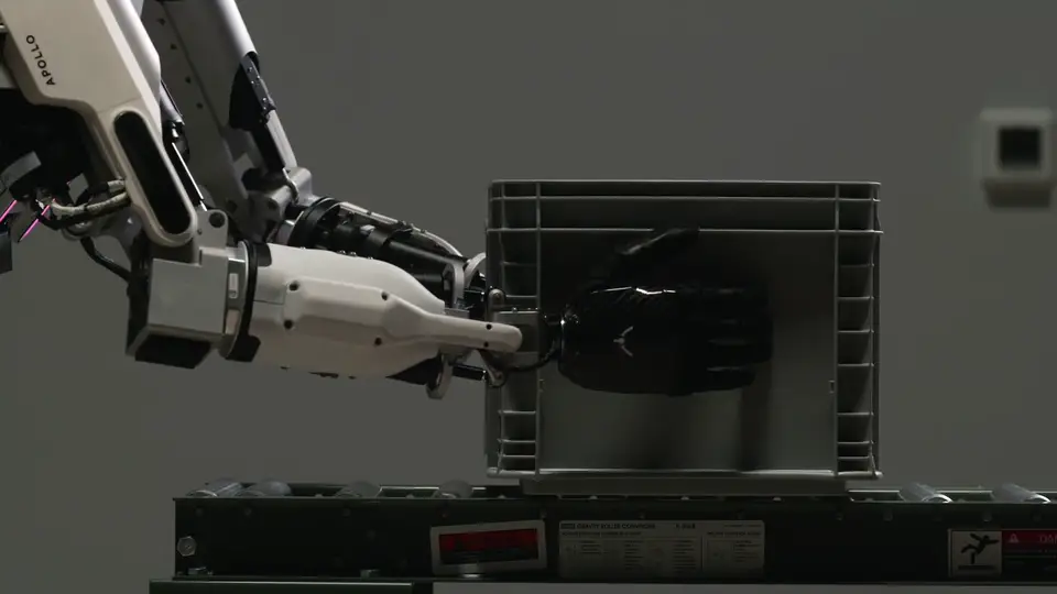 Apptronik humanoid robot moving totes in a logistics facility