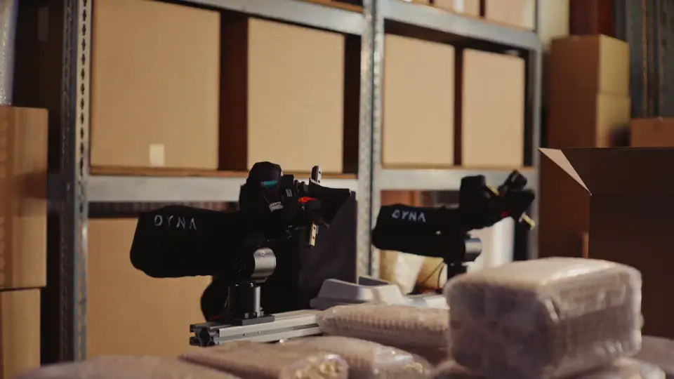Dyna Robotics arm folding laundry in a commercial laundry