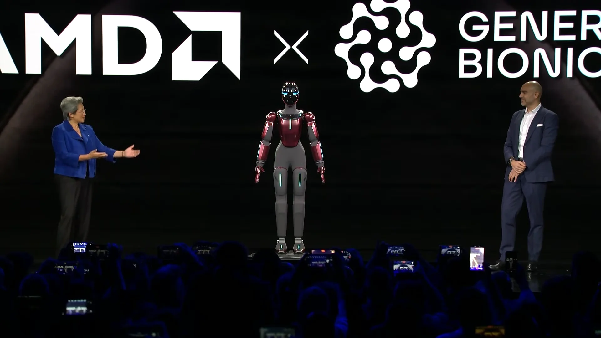 AMD CEO Dr. Lisa Su and Generative Bionics CEO Daniele Pucci on stage at CES 2026, gesturing toward the GENE.01 humanoid robot standing between them.