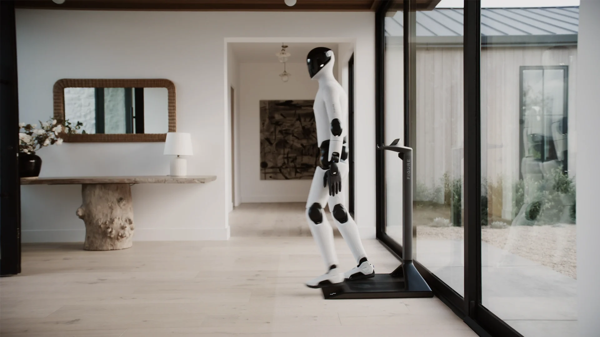 A white Figure 03 humanoid robot stepping off a black floor-mounted charging stand in a modern home.