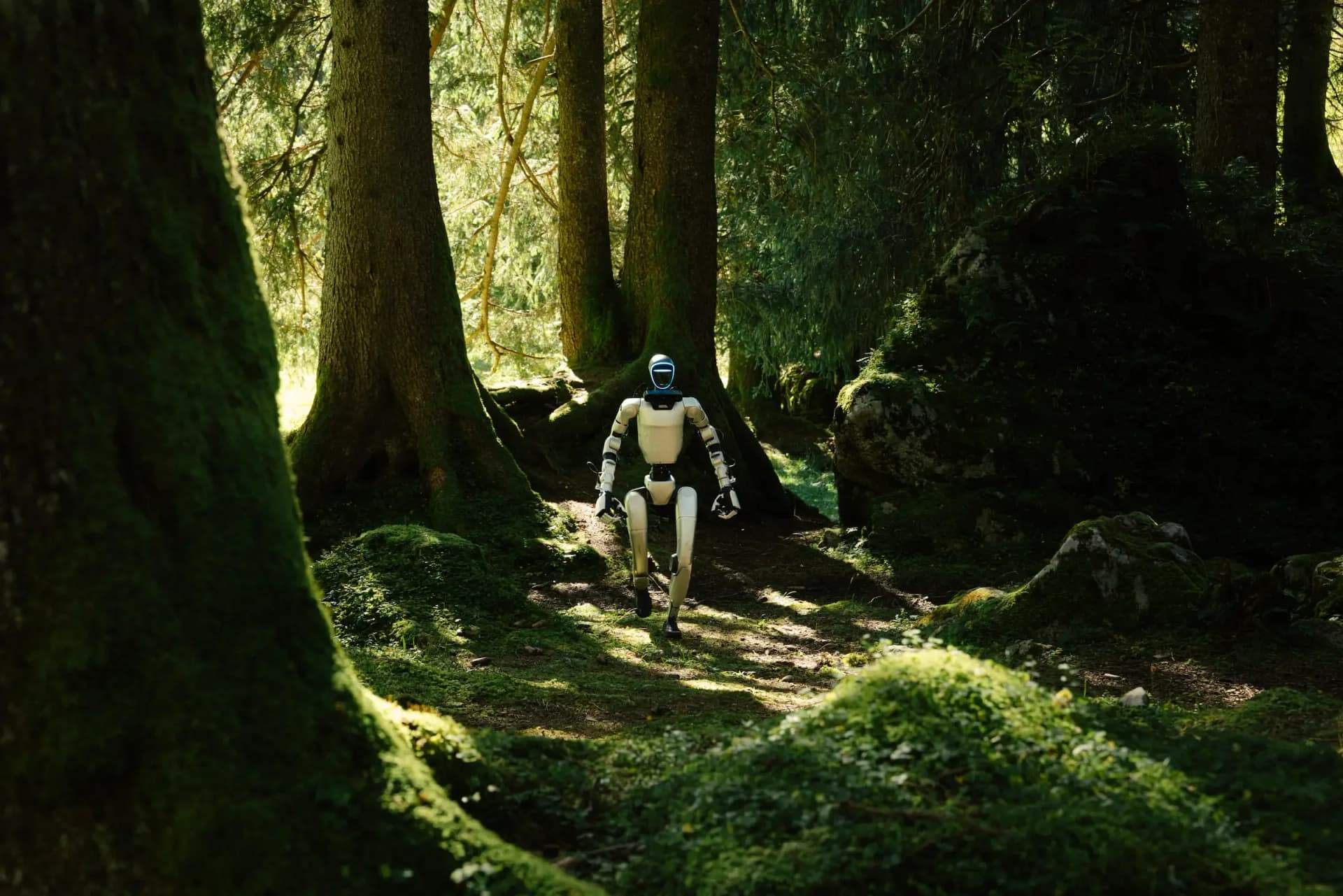 A Unitree G1 humanoid robot hiking through a lush green forest in the Swiss Alps.