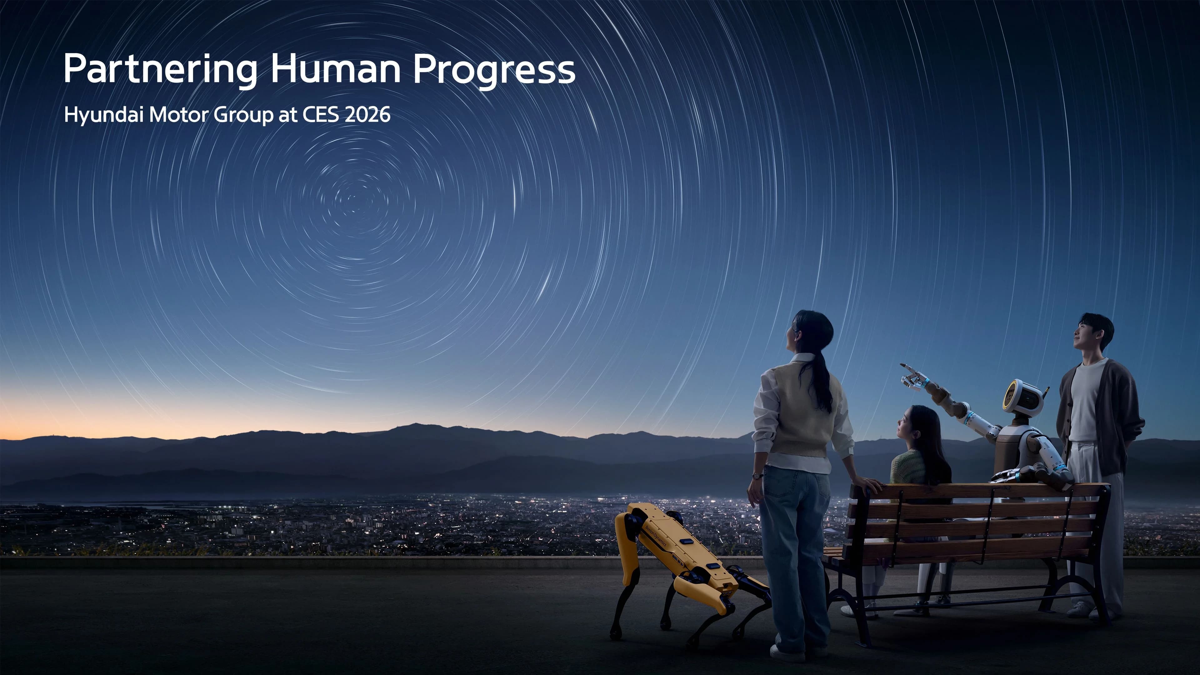 Promotional text reading "Partnering Human Progress: Hyundai Motor Group at CES 2026" overlaid on an image of robots and humans gazing at a starry sky.