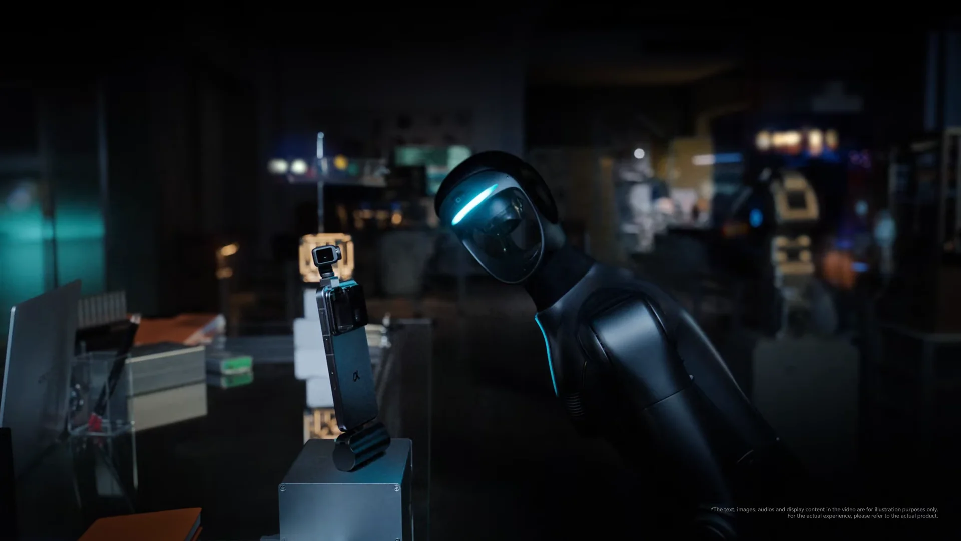 A sleek, matte black humanoid robot in a dimly lit laboratory leans over a desk to examine a smartphone featuring an integrated robotic gimbal camera.