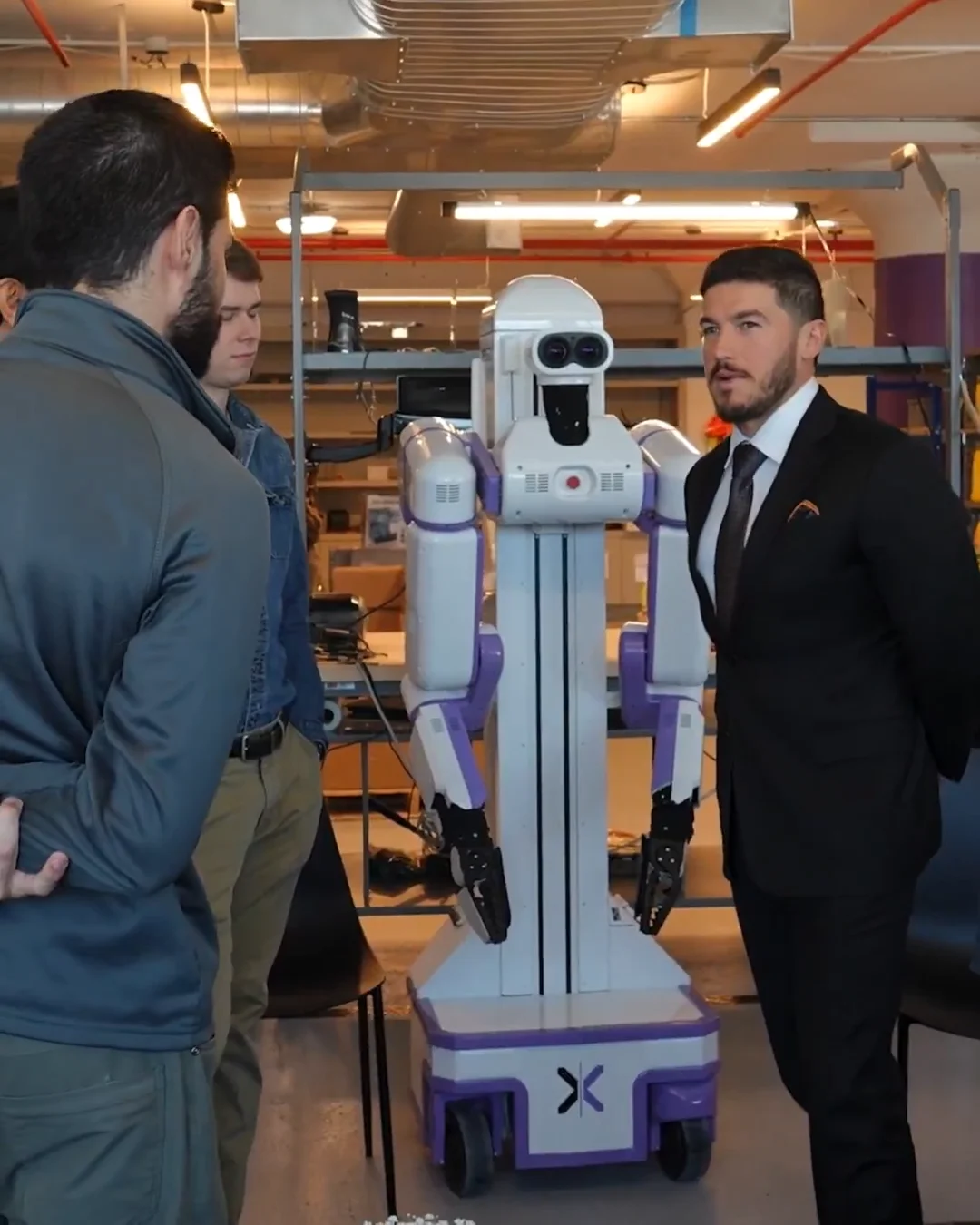 Nuevo Leon Governor Samuel García stands next to a Reflex Robotics humanoid robot during an announcement event.