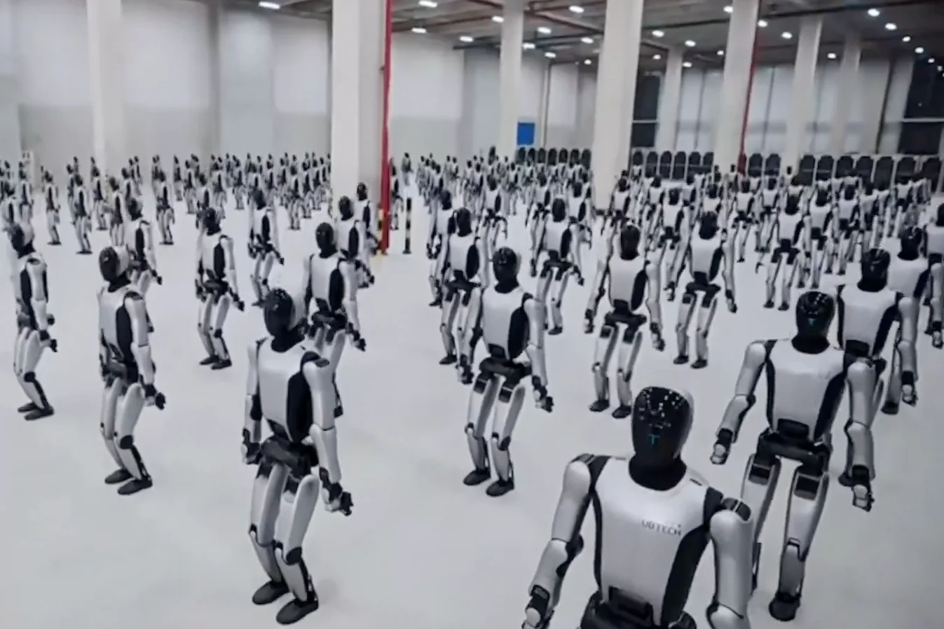 Multiple rows of UBTECH Walker S2 humanoid robots standing in a large hall