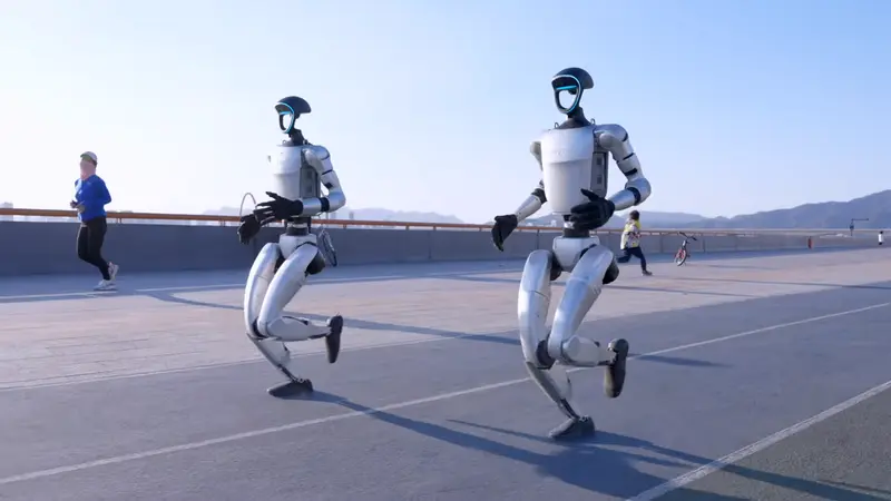 Two Unitree humanoid robots running
