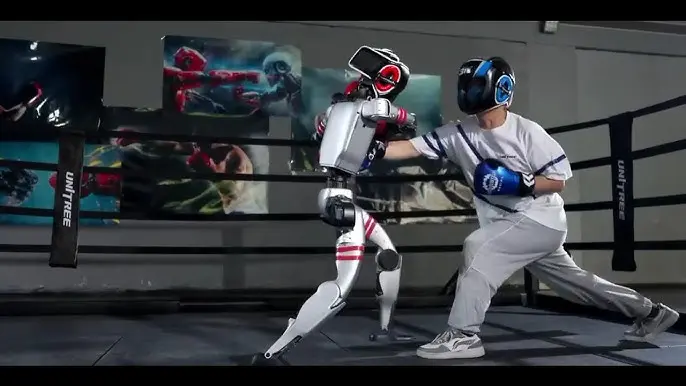 A human and a humanoid robot boxing