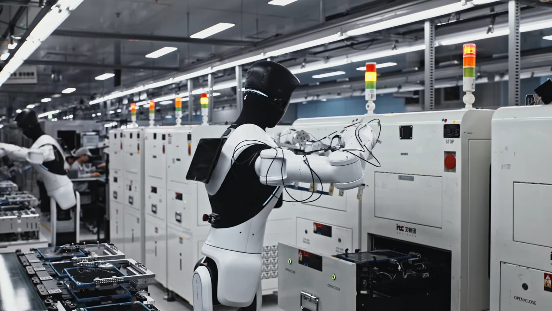 AGIBOT robots working at testing stations on a consumer electronics production line at Longcheer.