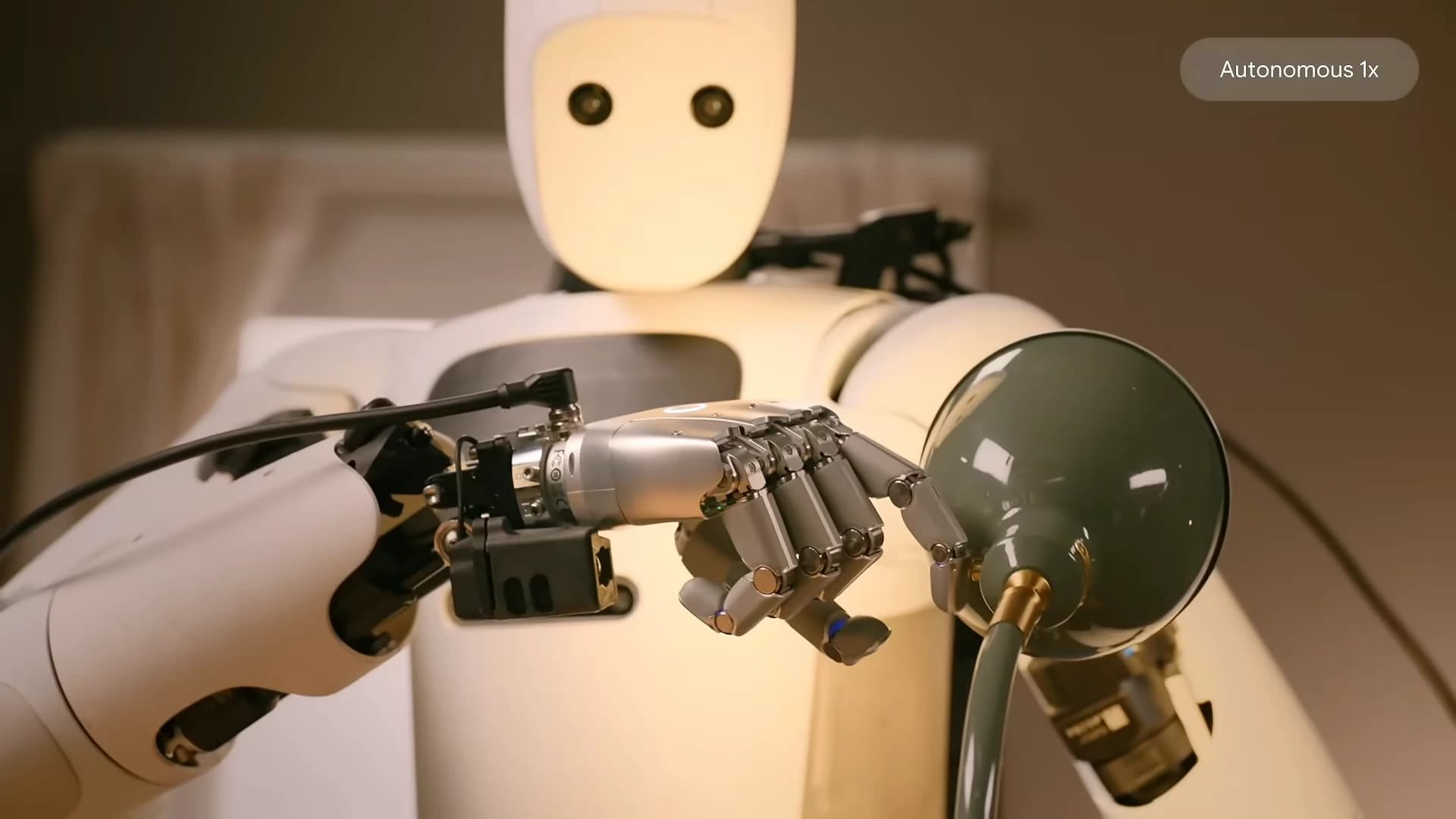 Apptronik Apollo fitted with SharpaWave hands manipulating a desk lamp in a Google DeepMind demonstration.