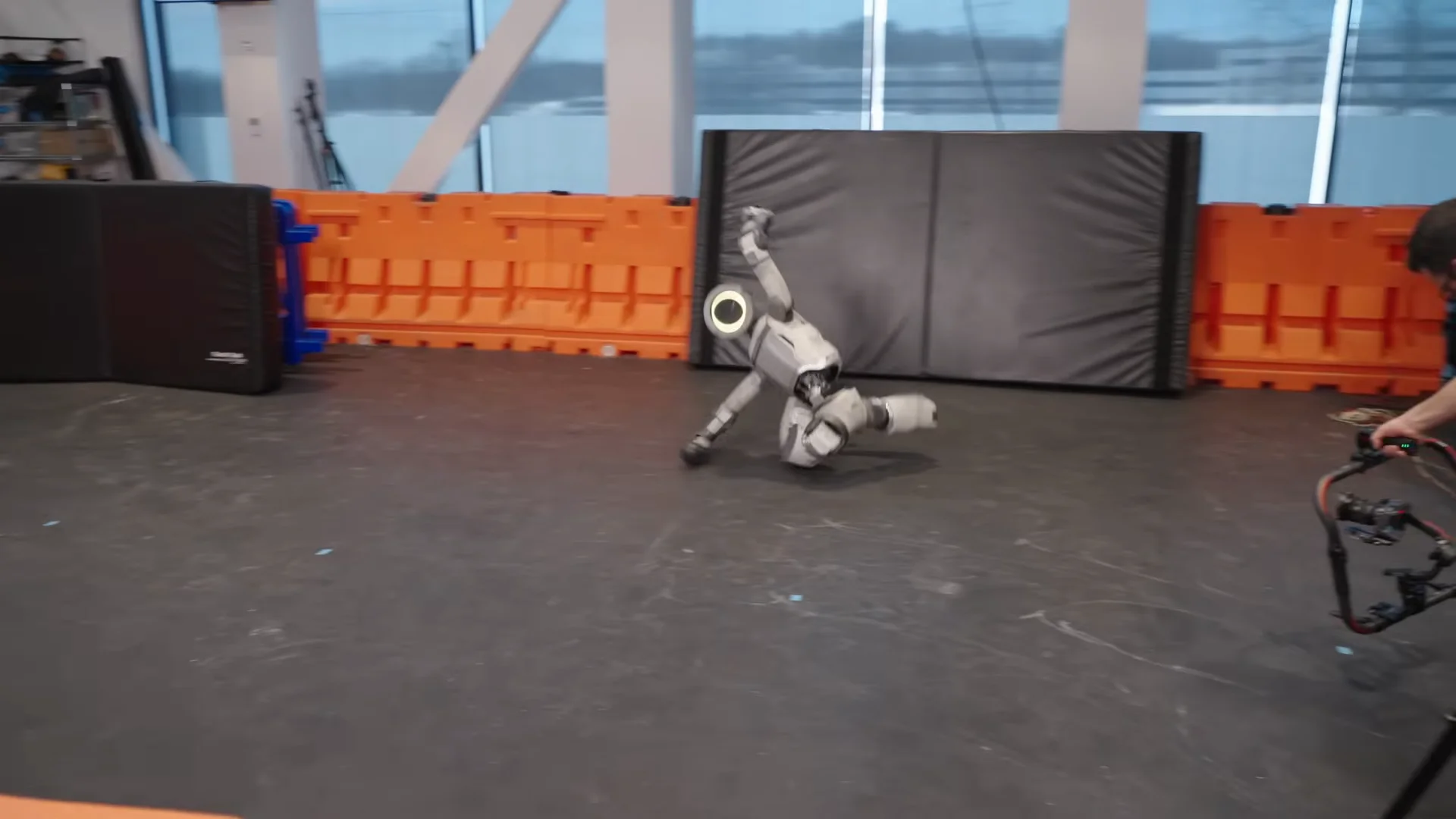 The research Atlas robot lying on its side on a lab floor after falling during a movement demonstration.