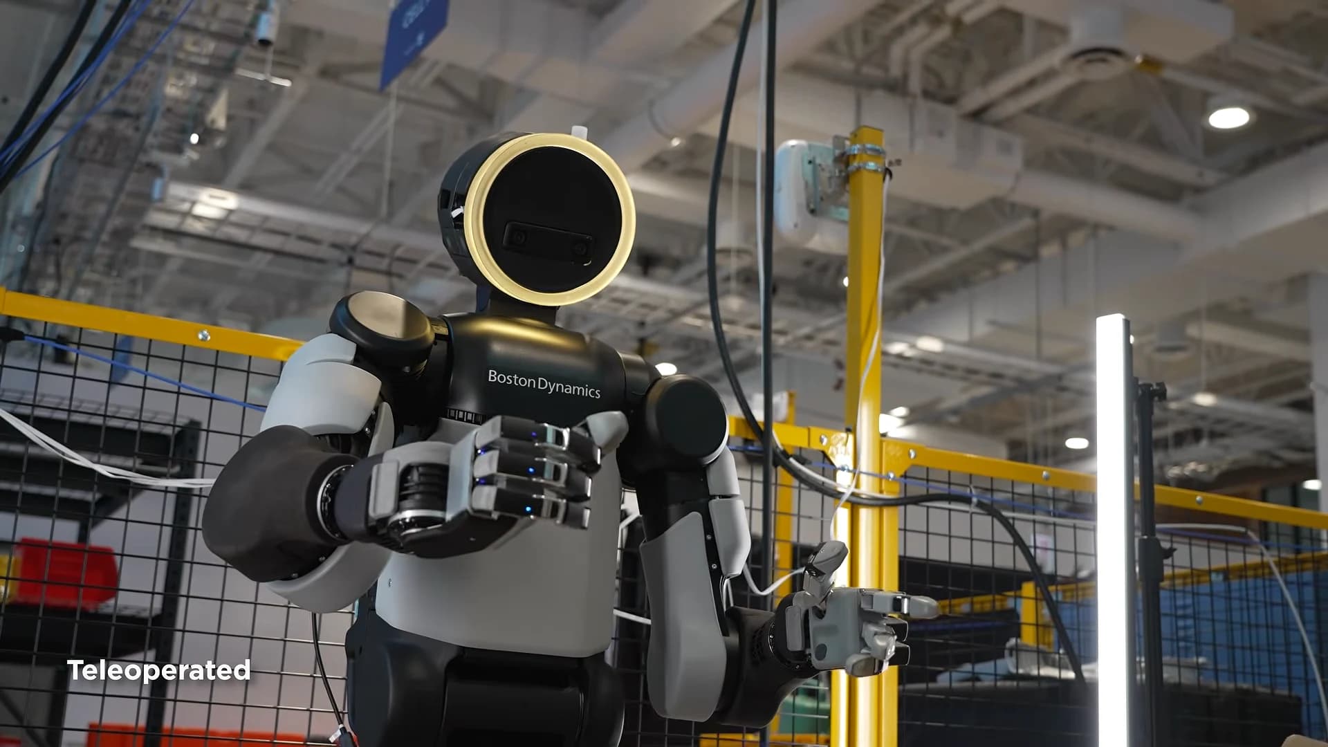 Atlas demonstrates its new four-finger hands in a workshop; the video frame is labeled Teleoperated.