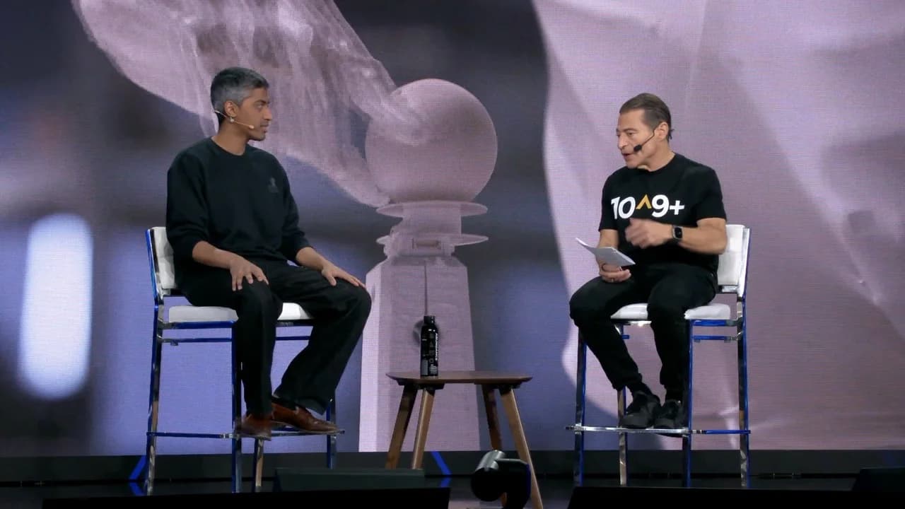 Dhanush Radhakrishnan and Peter Diamandis sitting on high chairs during a fireside chat at the 2026 Abundance Summit.