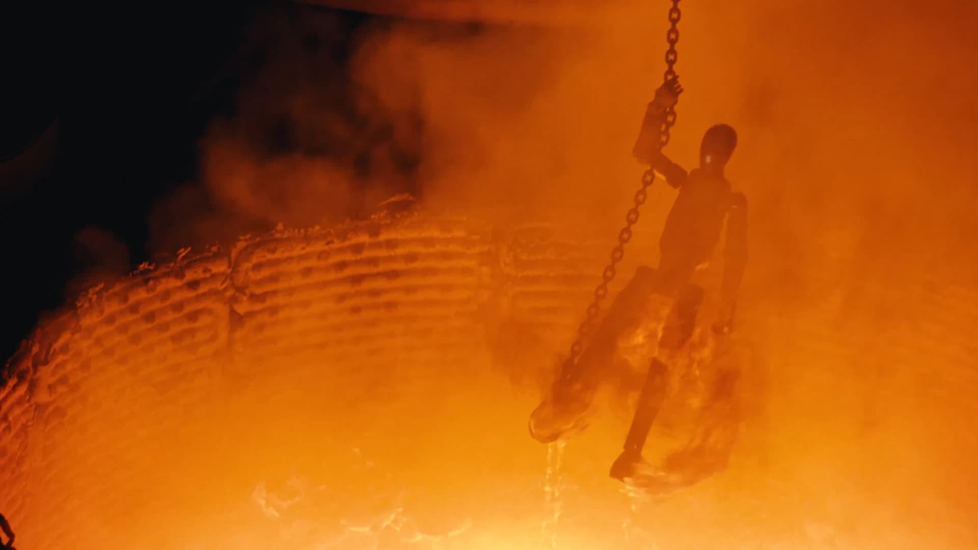 Figure 02 descends toward the furnace in a scene recalling Terminator 2.