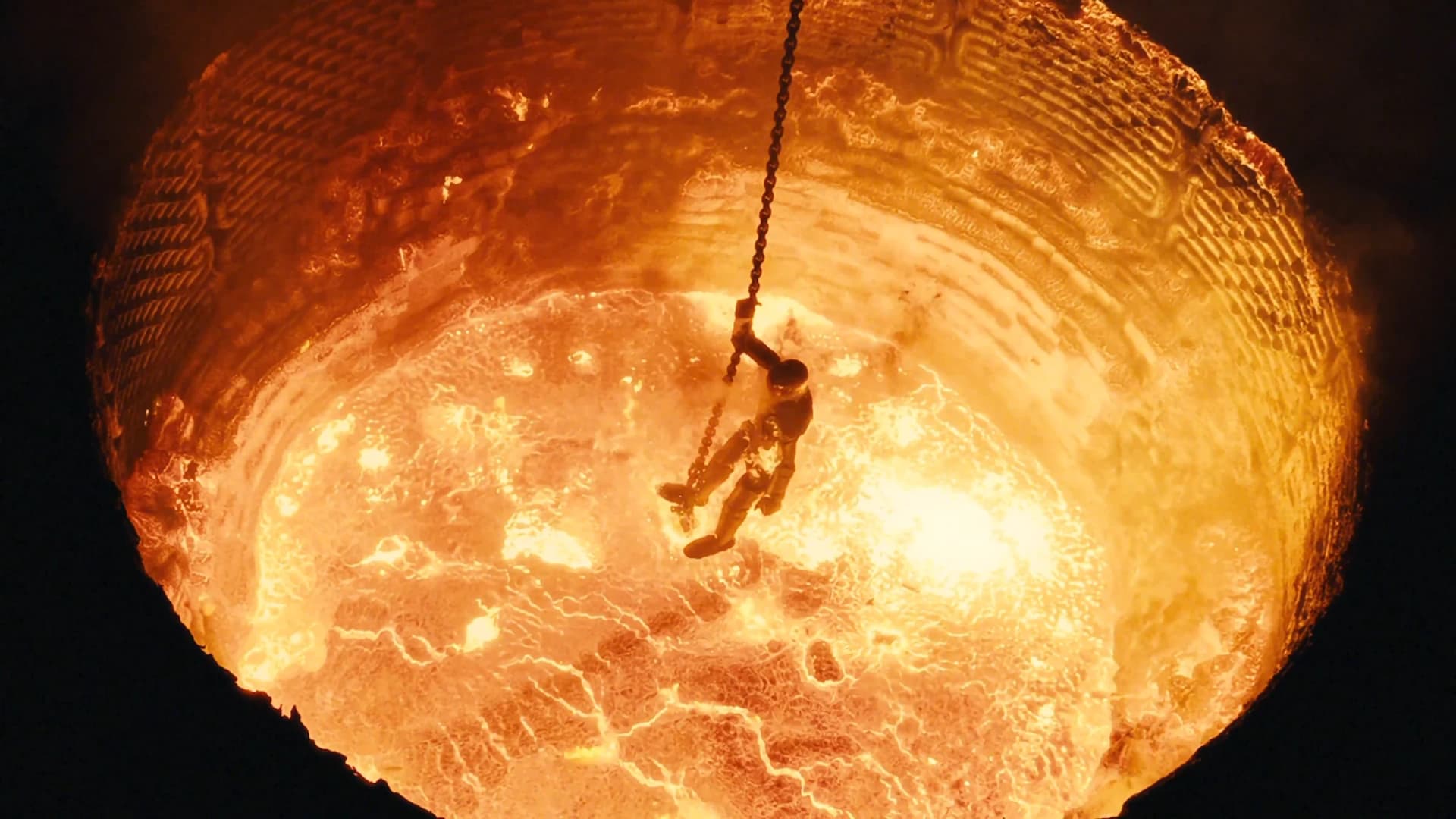 An overhead view of Figure 02 being lowered into the furnace.