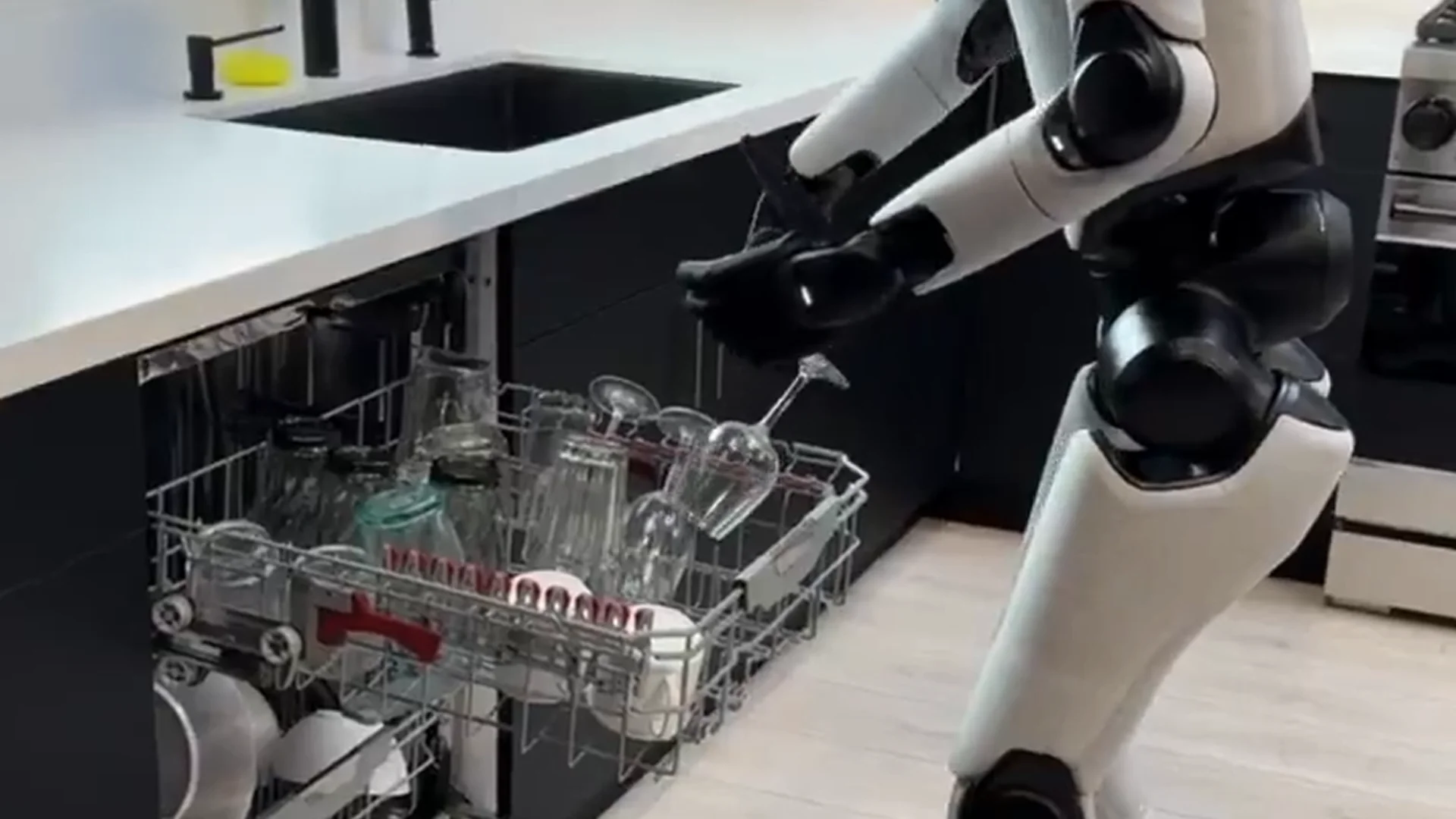 A Figure 03 robot handling a wine glass when loading a dish washer