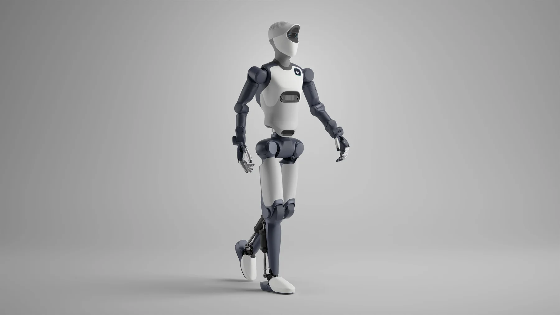 The Agile Robots Agile ONE humanoid walking mid-stride against a plain grey studio background, seen from the side in white and slate-grey panelling, with a smooth white cowled head containing a dark visor slot, a small "01" badge on the chest, and articulated five-finger hands with exposed metallic finger linkages.