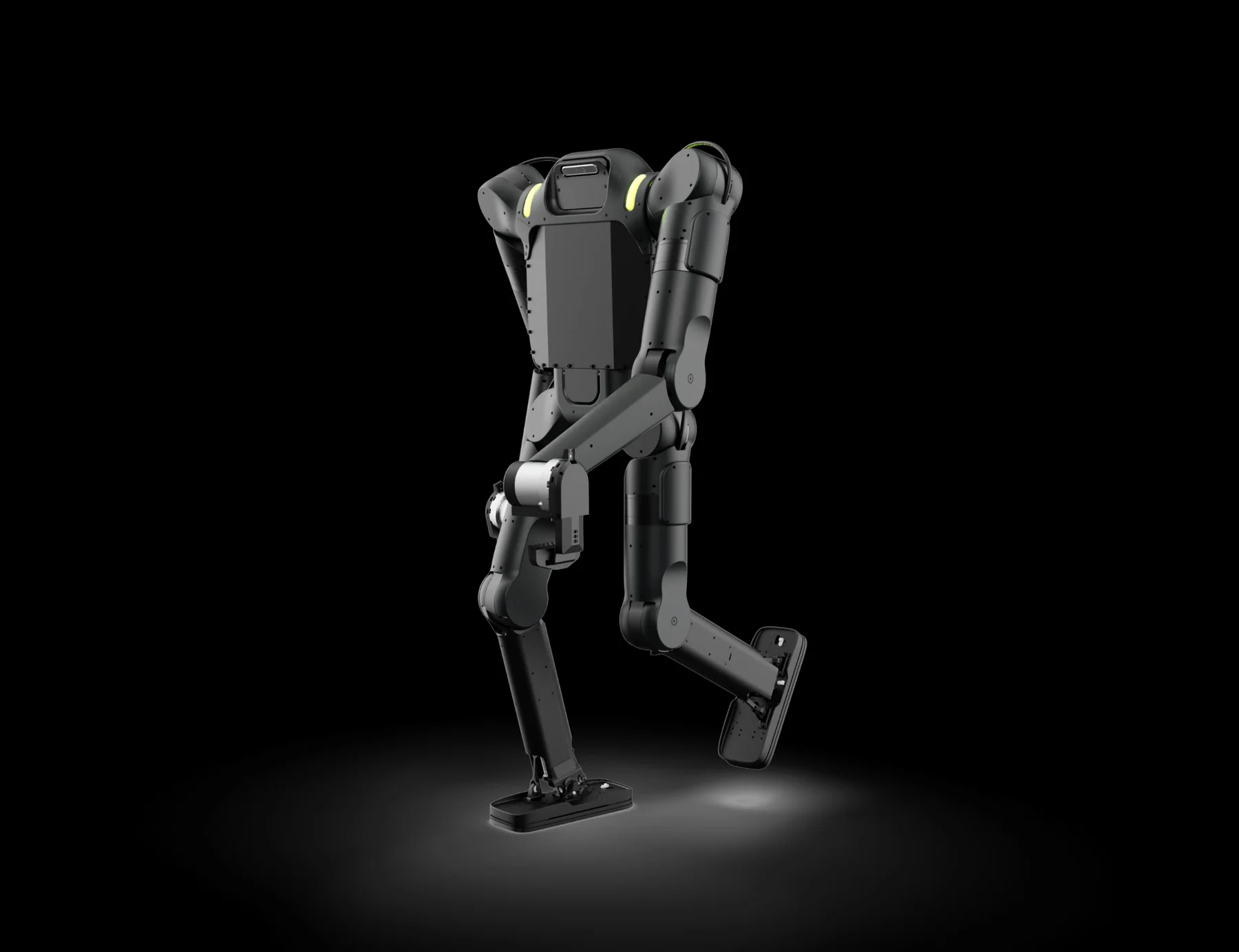 Wandercraft's Calvin-40 industrial humanoid mid-stride against a black background, a matte black bipedal machine with no head — the torso ending in a flat sensor housing — with yellow-green accents at the shoulder joints, exposed actuator modules at the hips and knees, and large flat rectangular feet.