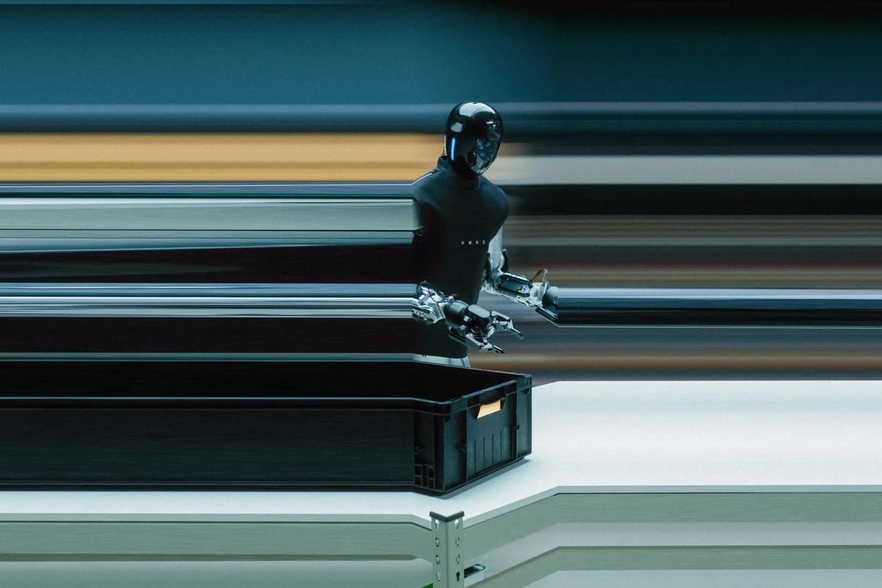 The HMND 01 Alpha robot, wearing a black fabric 'uniform,' stands beside a black industrial bin. Dramatic horizontal motion blur emphasizes the platform's high operational speed.