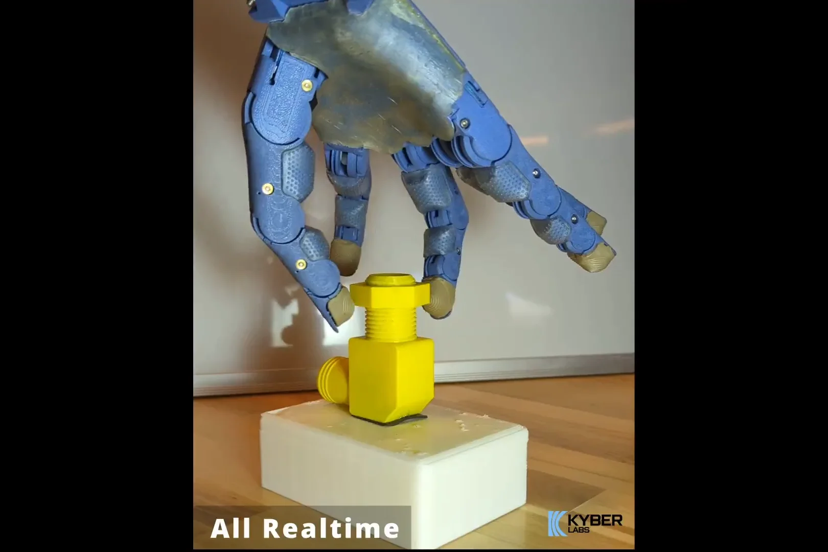 Kyber Labs robotic hand rotating a yellow nut on a bolt