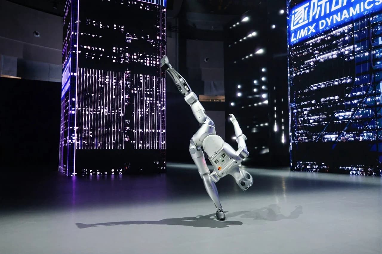 The LimX Luna humanoid robot performing an illusion turn gymnastics move on one leg with its other leg extended vertically toward the ceiling.