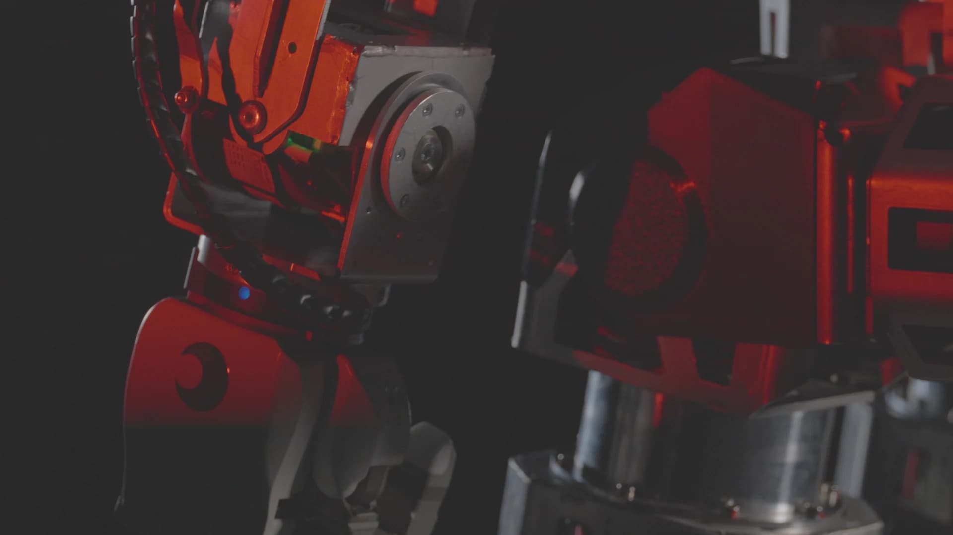 Close-up of Roger’s torso and arm assembly under red lighting.
