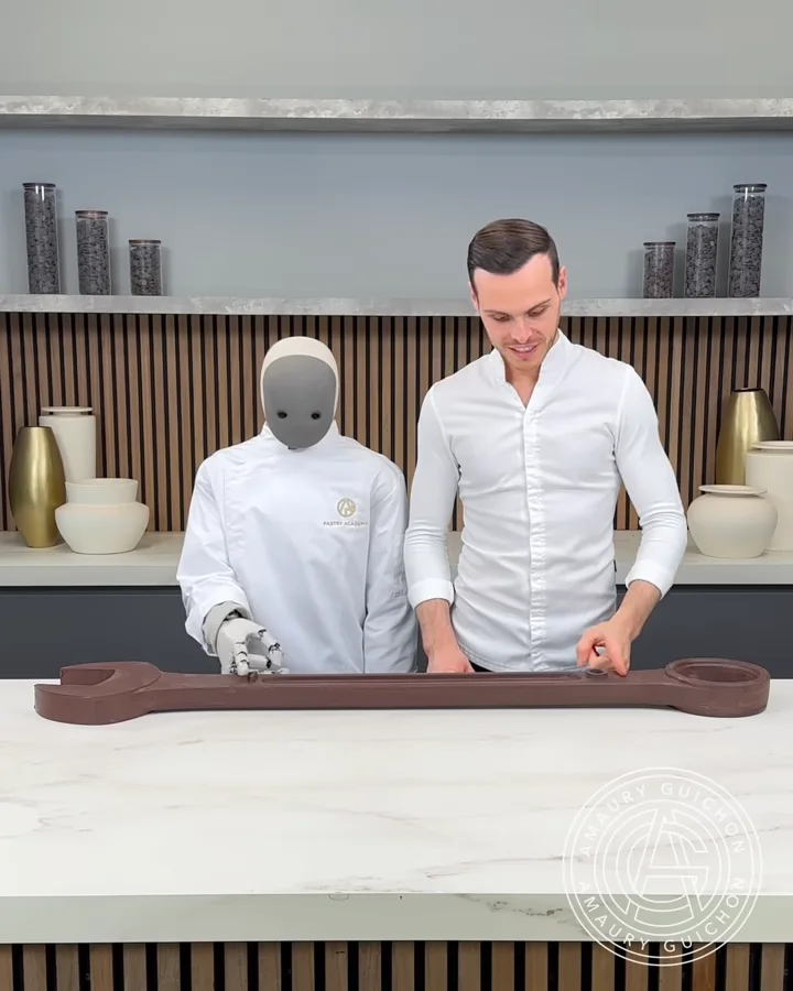 1X NEO humanoid robot working a dessert together with Amaury Guichon