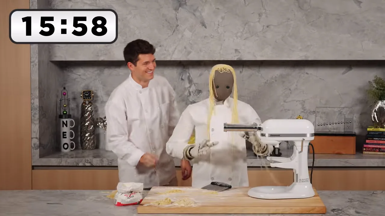1X Neo humanoid robot cooking pasta with YouTuber Nick DiGiovanni