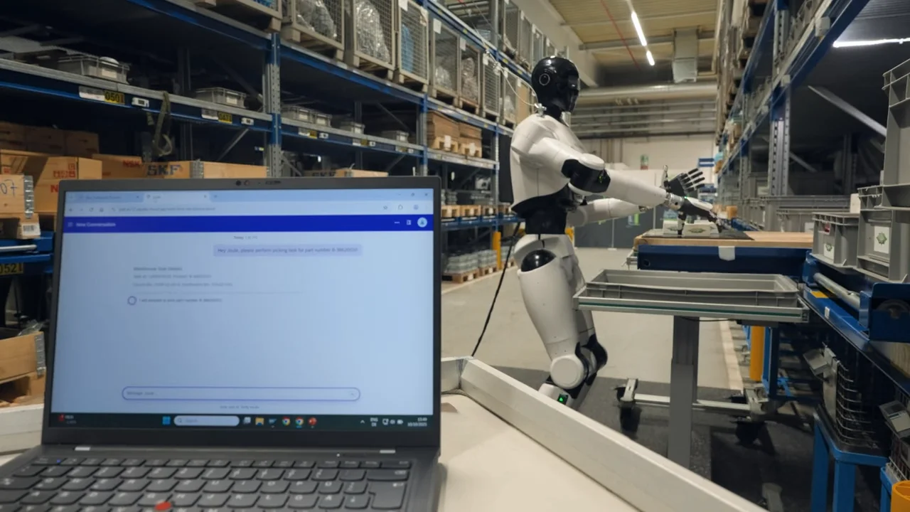 A laptop screen in the foreground displays a chat interface with a command to pick a product, while the NEURA Robotics 4NE-1 humanoid robot is visible in the background performing the picking task in a warehouse.