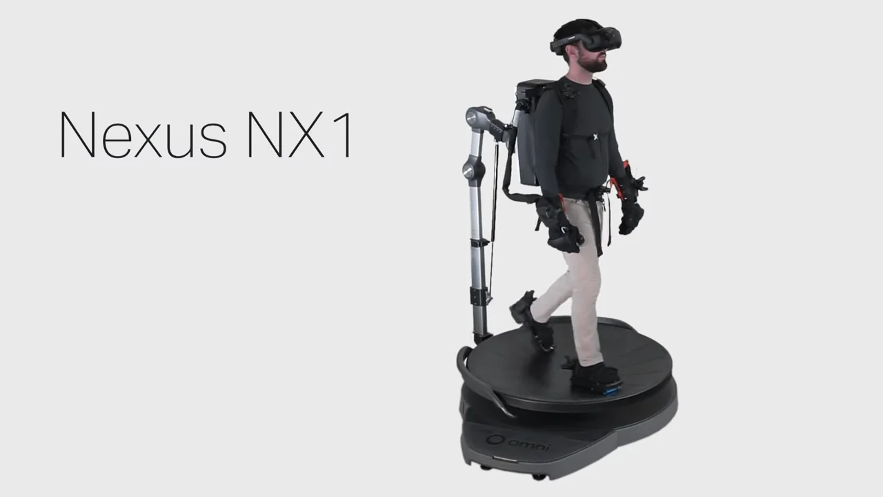 A person operating the Nexus NX1 system, strapped into a Virtuix Omni One treadmill and wearing a VR headset and bulky HaptX gloves.