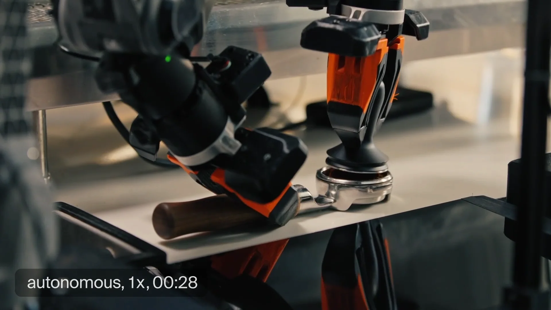Two robotic arms interacting with a commercial espresso machine