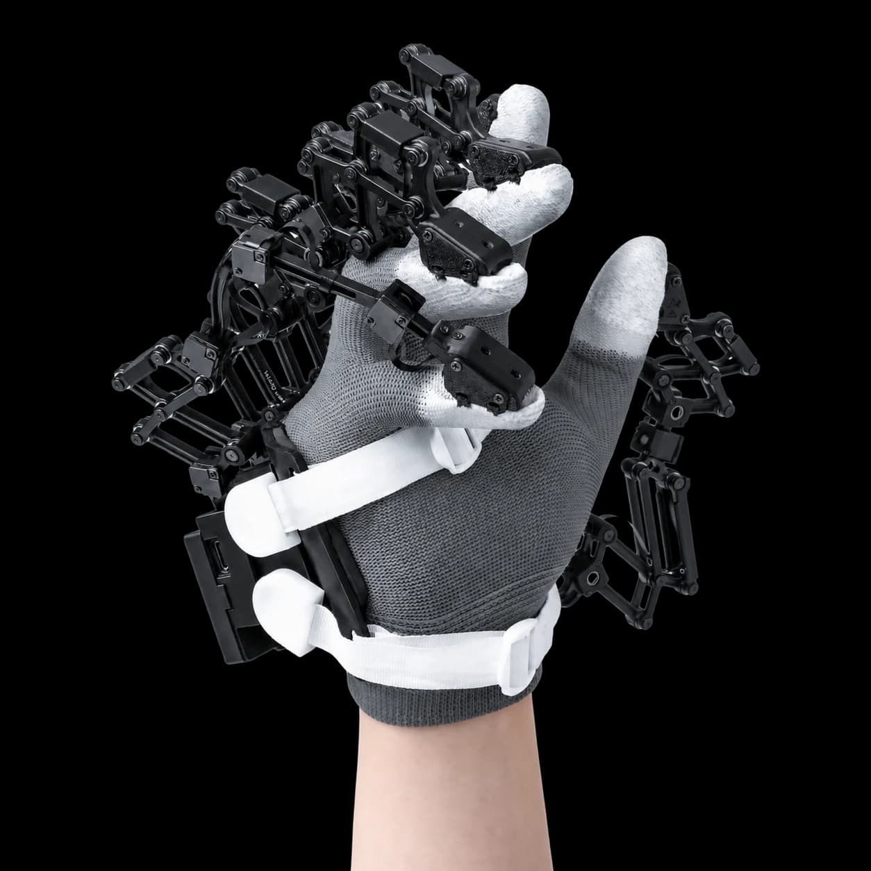 Close-up of the Avatar AE01 glove, with black mechanical linkages attached along the fingers and back of a gloved hand.