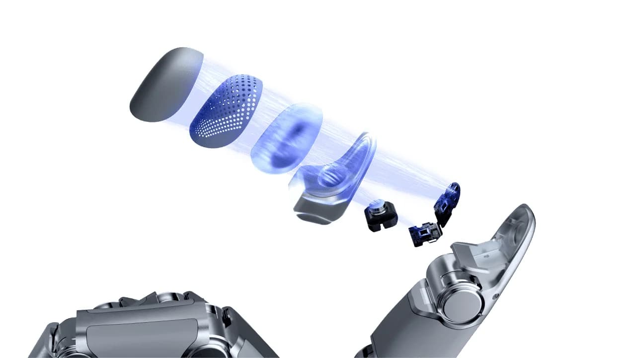 Exploded illustration of a Sharpa fingertip showing the outer contact surface, optical layers, miniature camera and internal electronics.