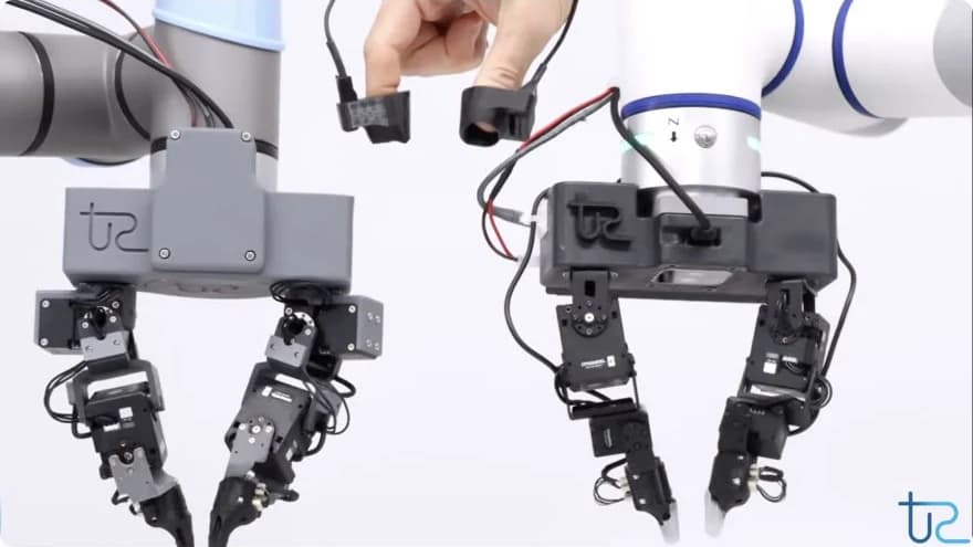 Two Tangent Robotics hands alongside a human operator wearing fingertip tracking devices.