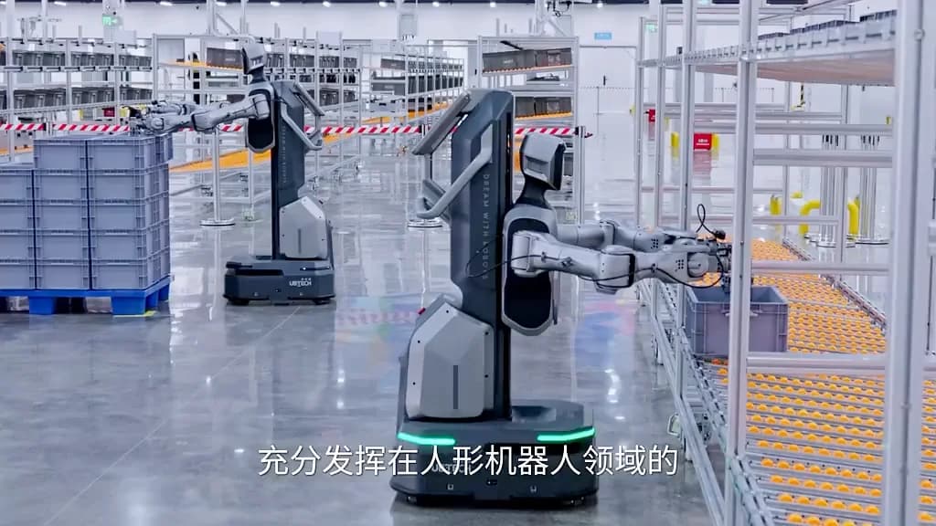 Two UBTECH Cruzr wheeled mobile manipulators equipped with dual articulated arms pick and place plastic component totes along an automated roller rack system on the factory floor.