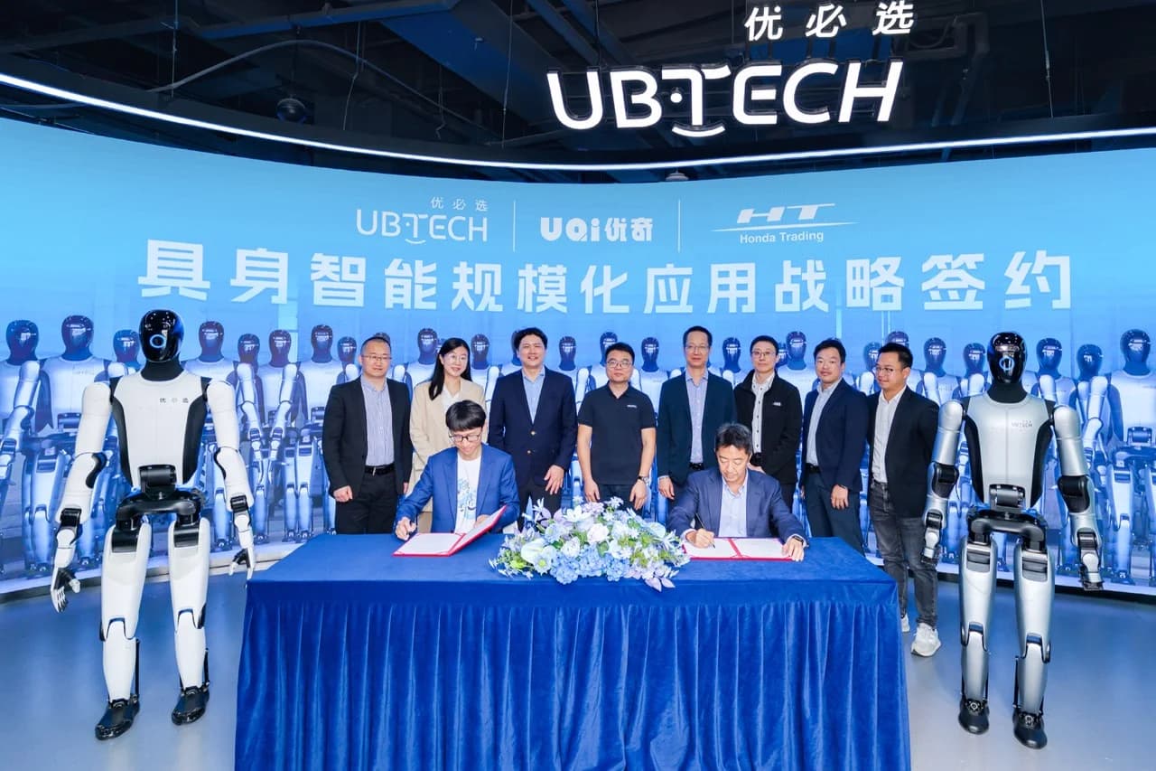 Representatives from UBTECH, its subsidiary UQI, and Honda Trading stand behind a blue-draped table during a formal signing ceremony flanked by two different models of humanoid robots.