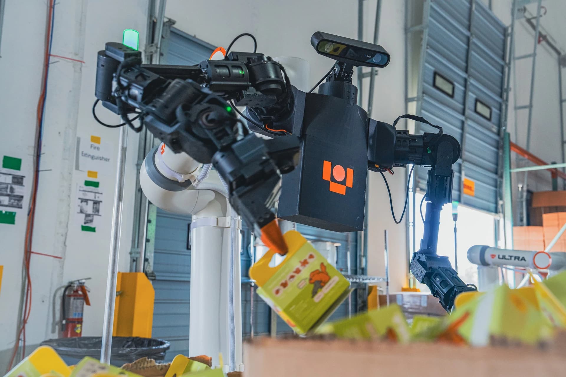 Ultra OP1 robot handling a packaged product at a warehouse workstation.