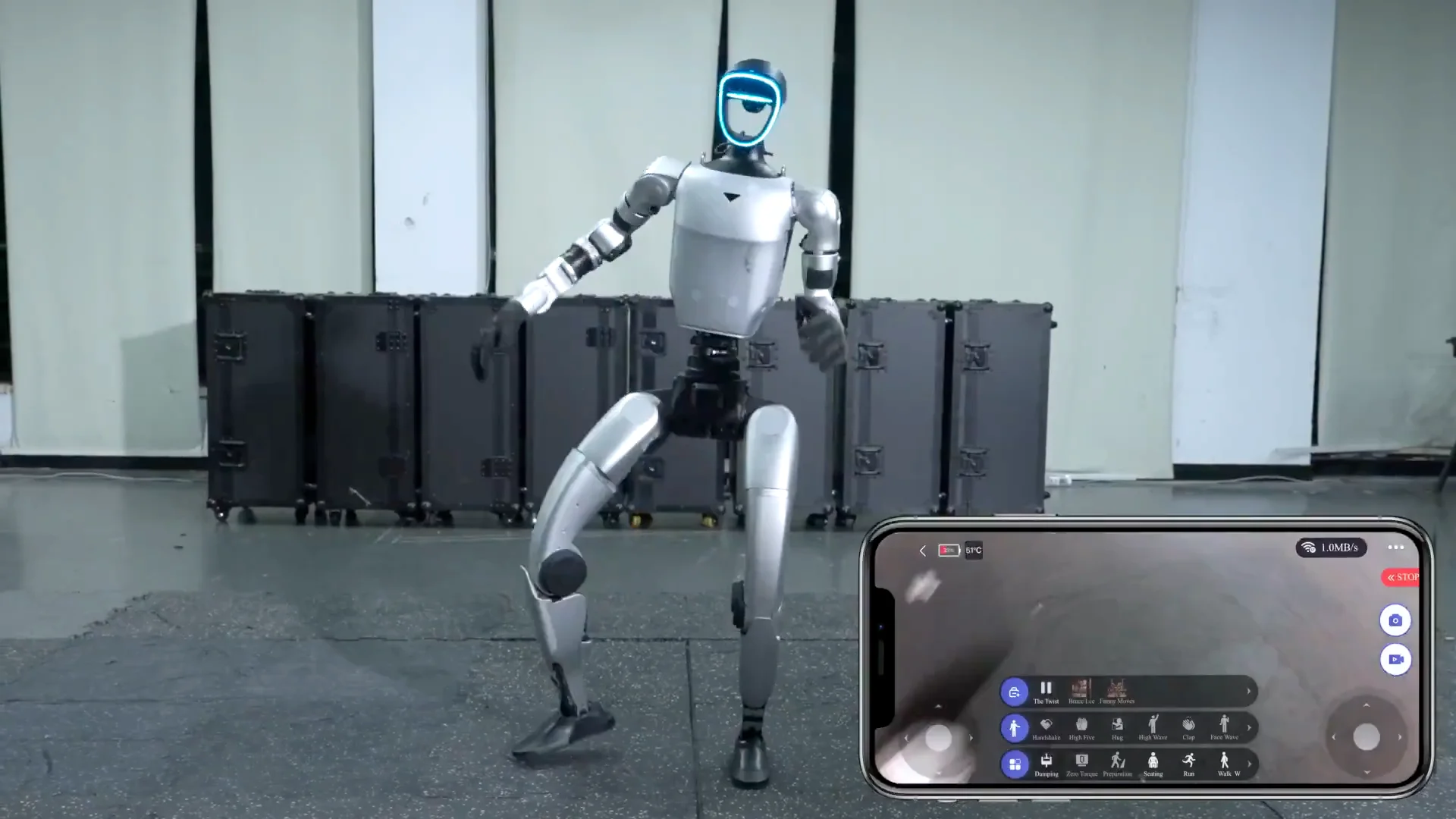 A silver Unitree G1 humanoid robot performing a twisting dance move in a studio, with an overlay of a smartphone screen showing the control interface executing "The Twist" action.