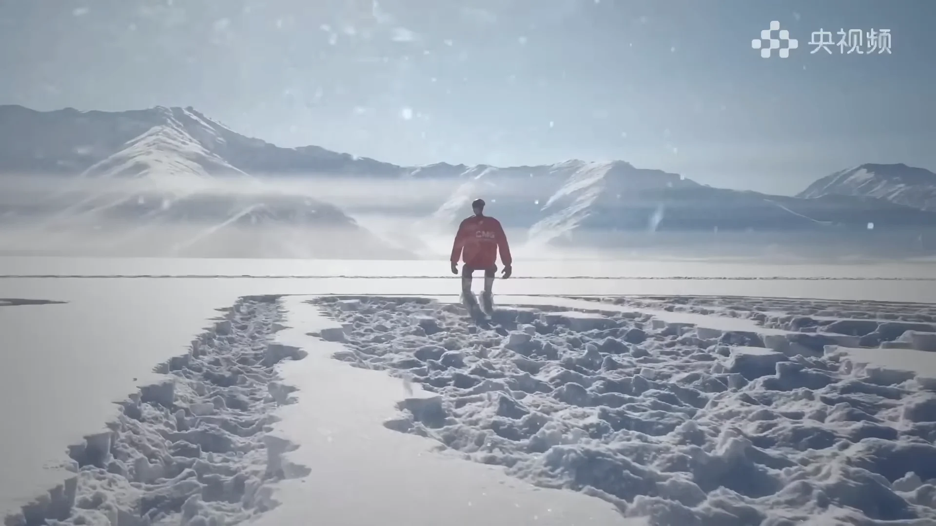 The Unitree G1 robot walking through deep, churned-up snow with snow-capped mountains in the background during its extreme cold autonomous walking challenge.