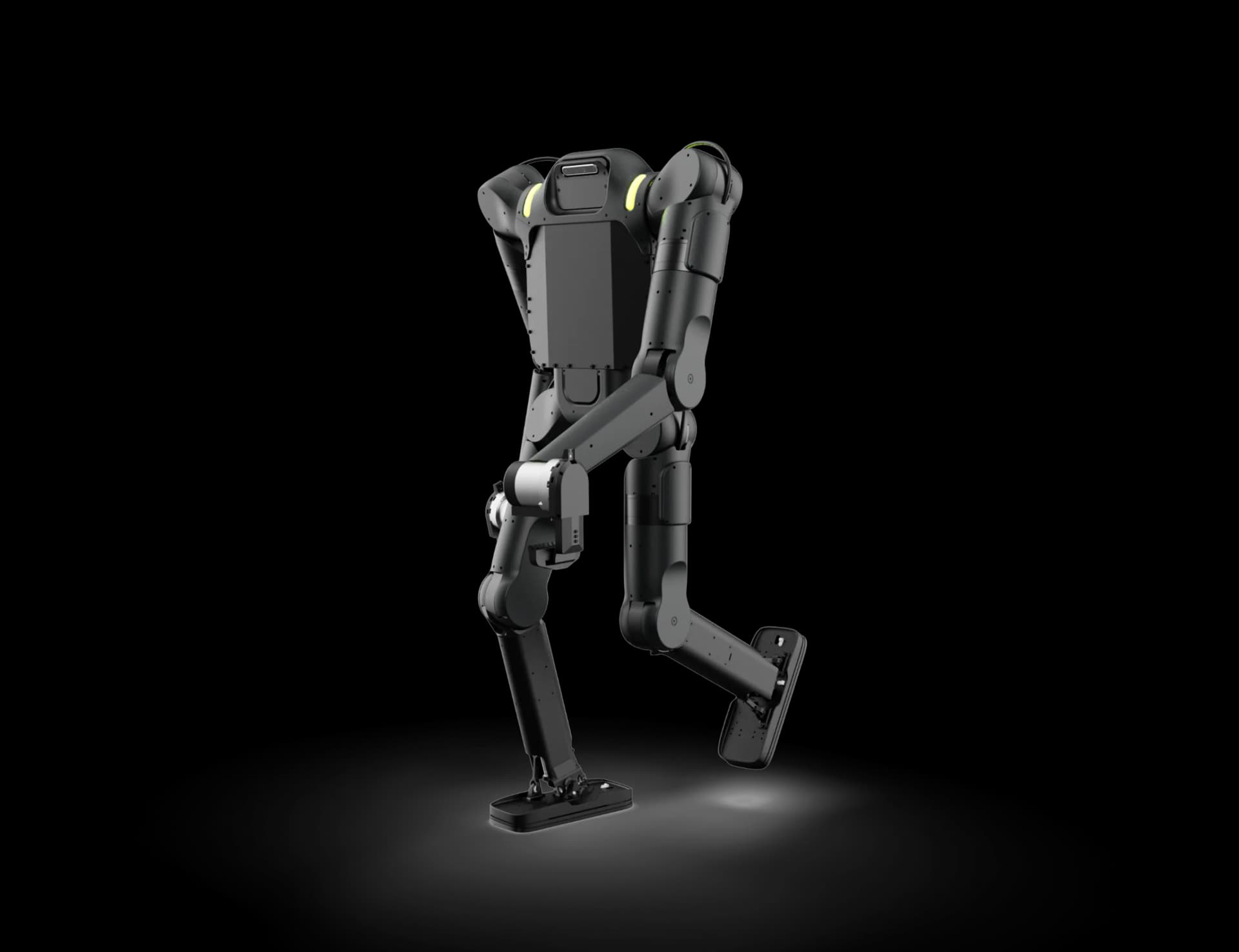 A matte black Wandercraft Calvin-40 industrial humanoid robot captured mid-stride from a three-quarter rear angle against an isolated white background, highlighting its robust bipedal legs, wide rectangular footpads, and compact torso frame.