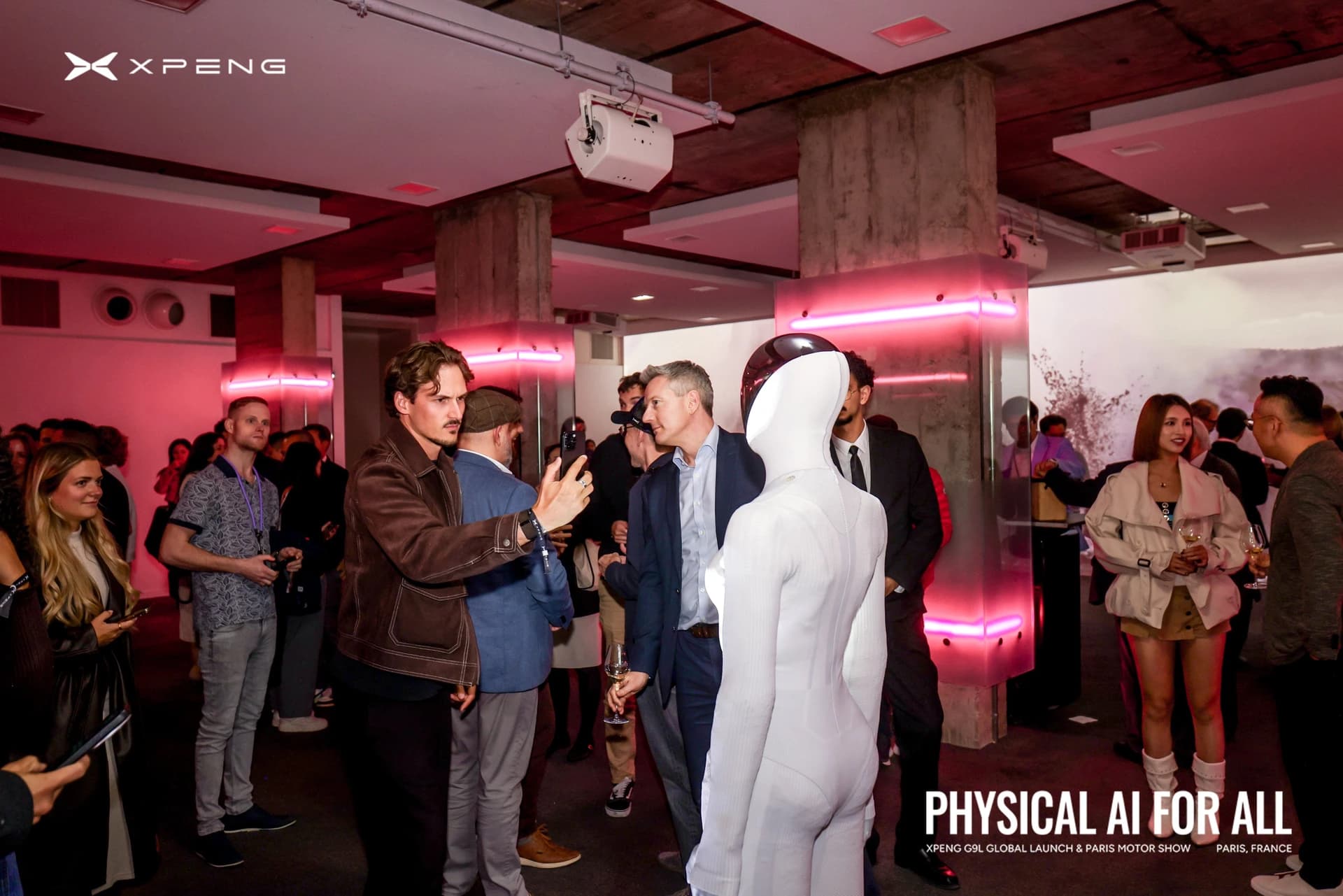 XPENG’s IRON humanoid robot among guests at the company’s Paris event.